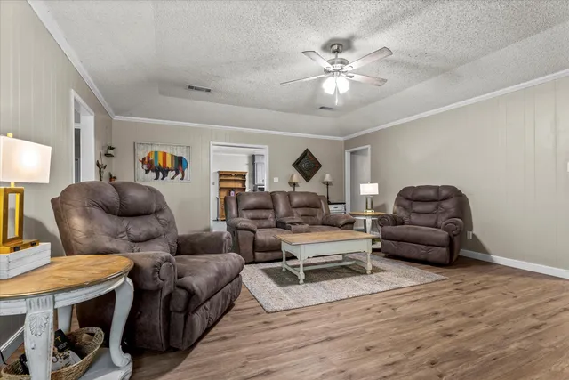 a living room with furniture and a chandelier