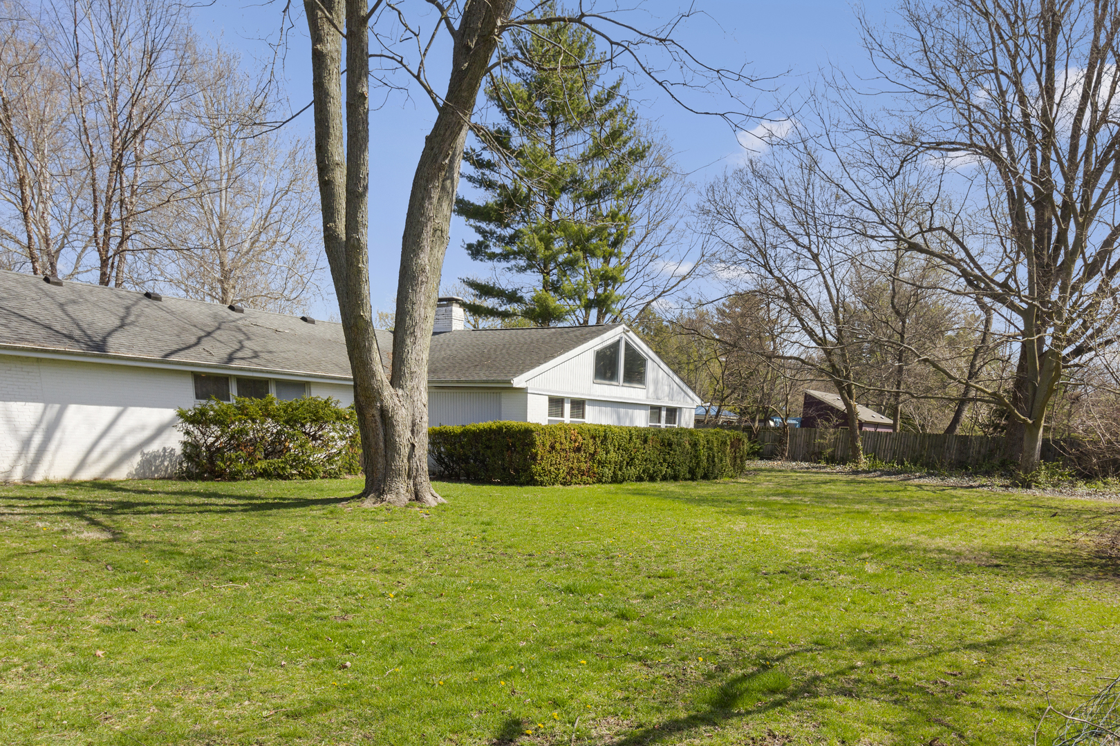 45 Greencroft Drive Champaign, IL 61821 - Photo 3 of 26 a view of a house with garden and trees