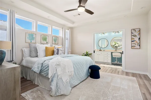 a bedroom with a bed and painting on the wall