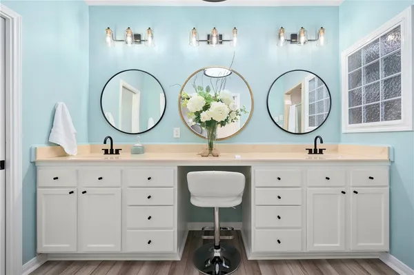 a bathroom with a double vanity sink and a mirror