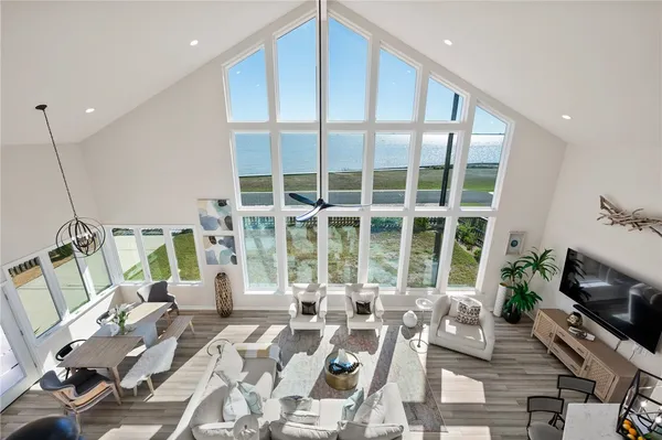 a bedroom with a bed a couch and a potted plant