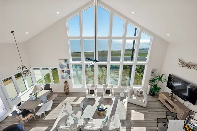 a bedroom with a bed a couch and a potted plant