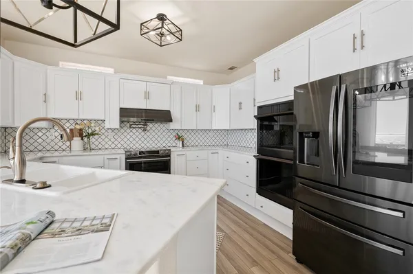 a kitchen with a refrigerator and a sink