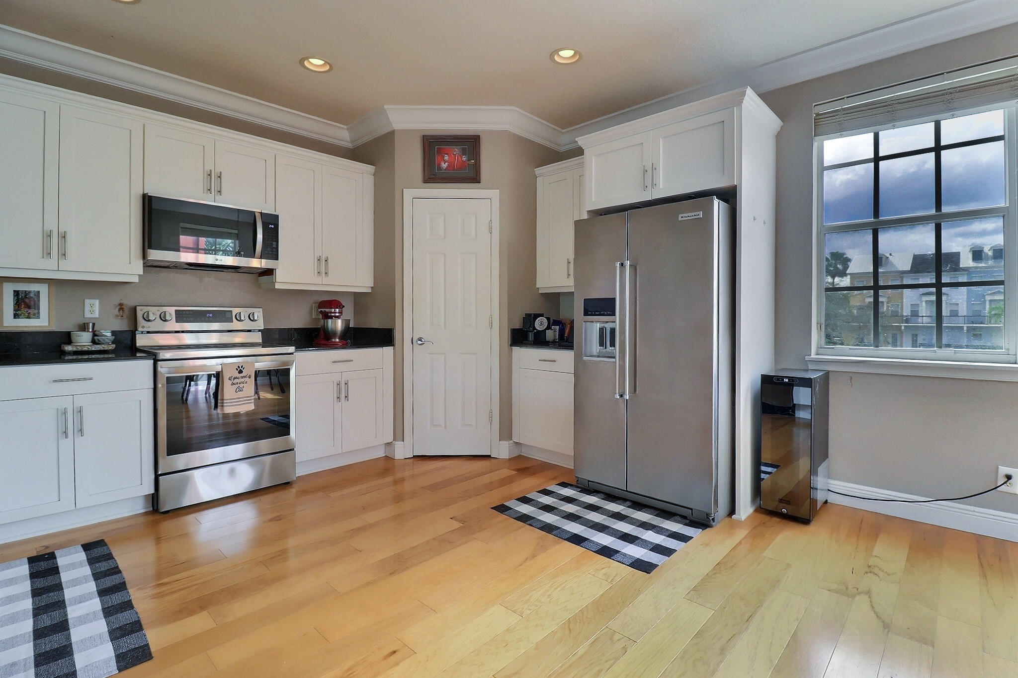 216 Quarry Knoll Way Jupiter, FL 33458 - Photo 6 of 23 a kitchen with stainless steel appliances a stove a sink and a refrigerator