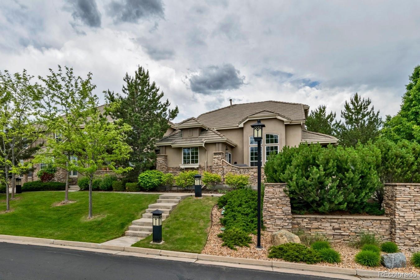 8974 Old Tom Morris Circle Highlands Ranch, CO 80129 - Photo 1 of 28 a front view of a house with garden