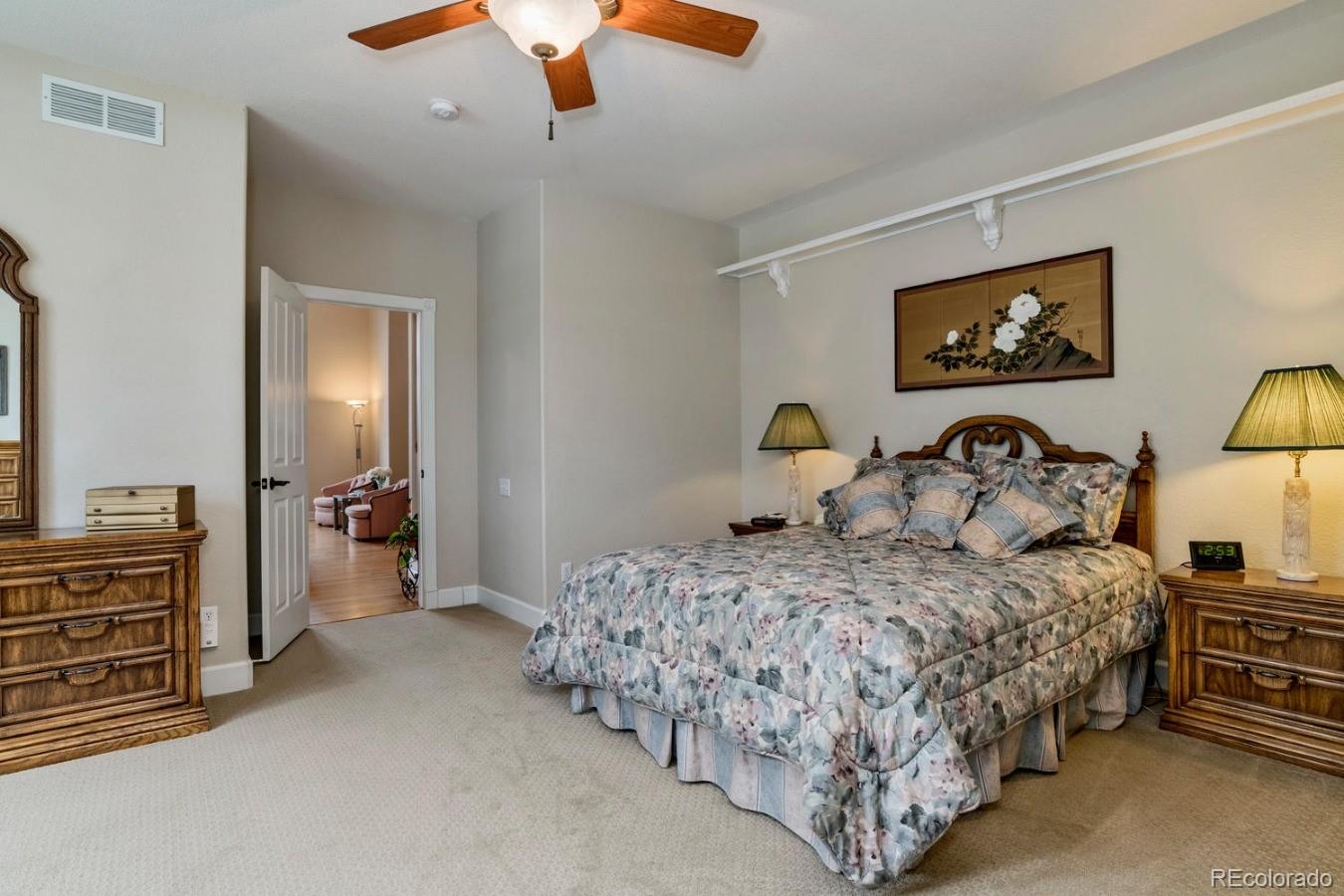 8974 Old Tom Morris Circle Highlands Ranch, CO 80129 - Photo 13 of 28 a bedroom with a bed and a chandelier