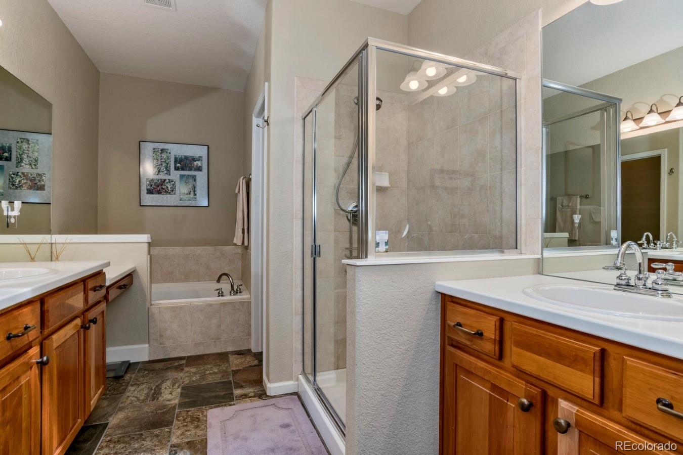 8974 Old Tom Morris Circle Highlands Ranch, CO 80129 - Photo 15 of 28 a bathroom with a sink a mirror and a bathtub