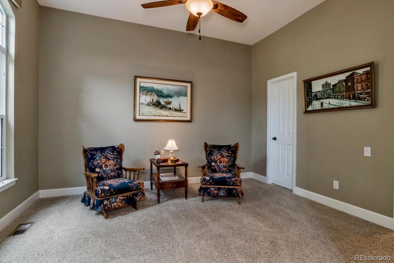 8974 Old Tom Morris Circle Highlands Ranch, CO 80129 - Photo 17 of 28 a living room with furniture and a chandelier