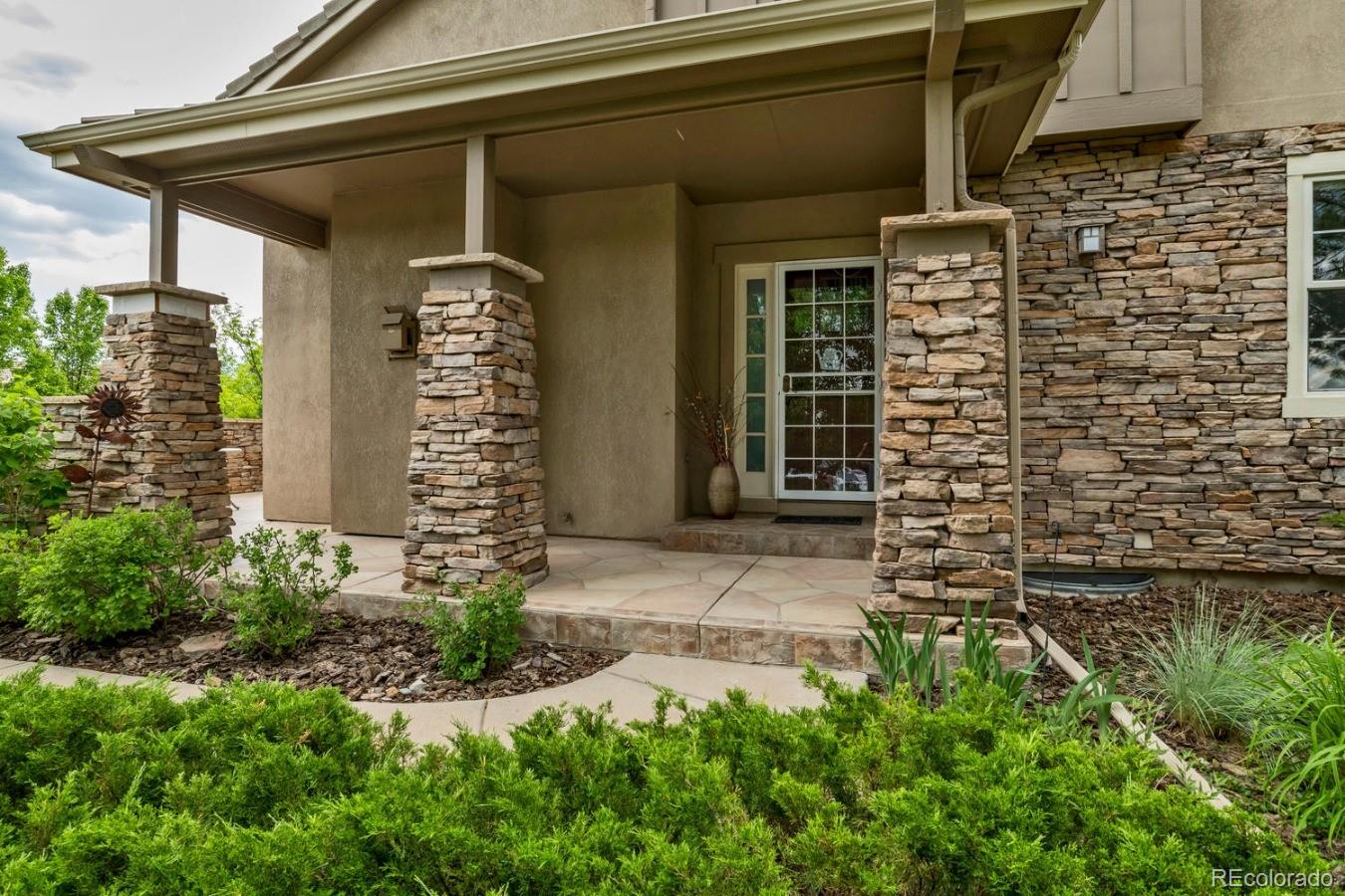 8974 Old Tom Morris Circle Highlands Ranch, CO 80129 - Photo 2 of 28 a front view of a house with plants