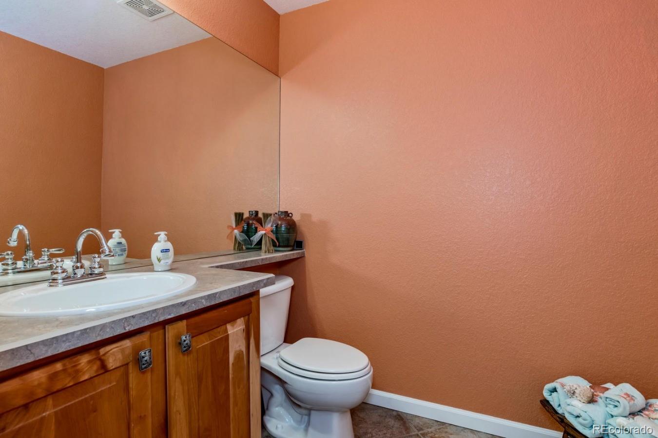 8974 Old Tom Morris Circle Highlands Ranch, CO 80129 - Photo 22 of 28 a bathroom with a granite countertop sink and a toilet