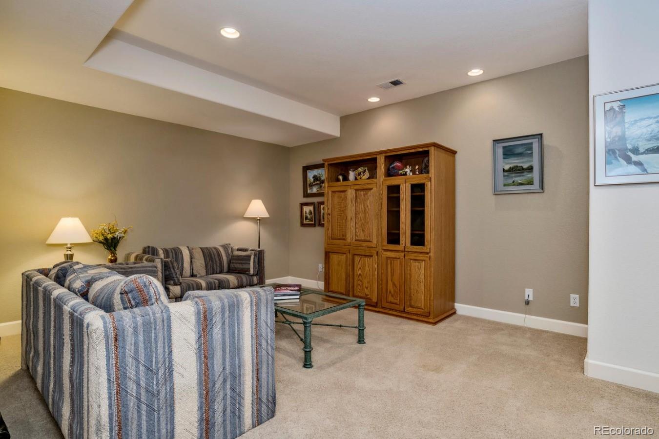 8974 Old Tom Morris Circle Highlands Ranch, CO 80129 - Photo 24 of 28 a bedroom with furniture and a lamp