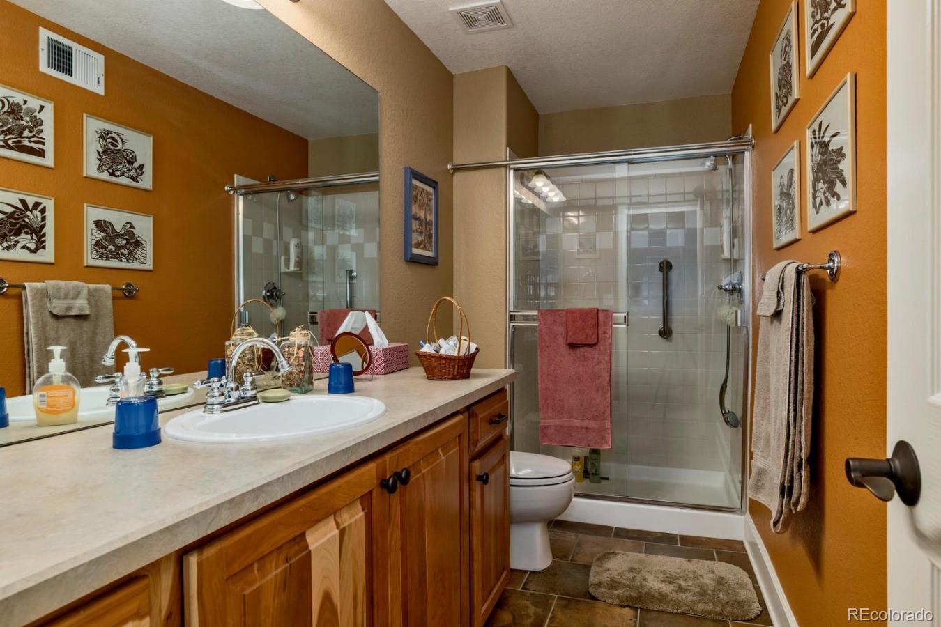 8974 Old Tom Morris Circle Highlands Ranch, CO 80129 - Photo 27 of 28 a bathroom with a sink a toilet and shower