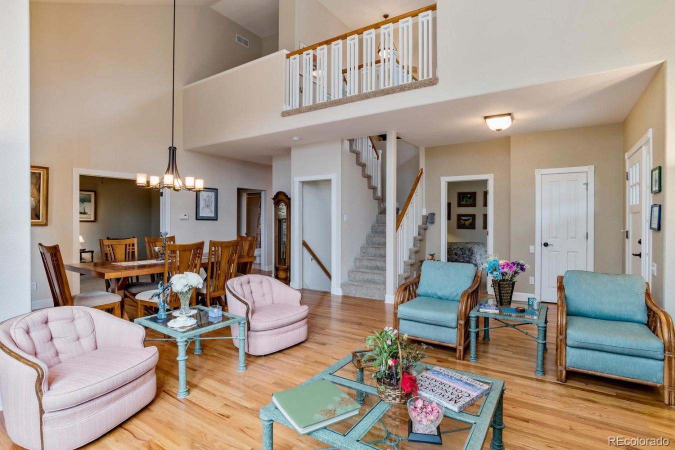 8974 Old Tom Morris Circle Highlands Ranch, CO 80129 - Photo 5 of 28 a living room with furniture or couch and a wooden floor