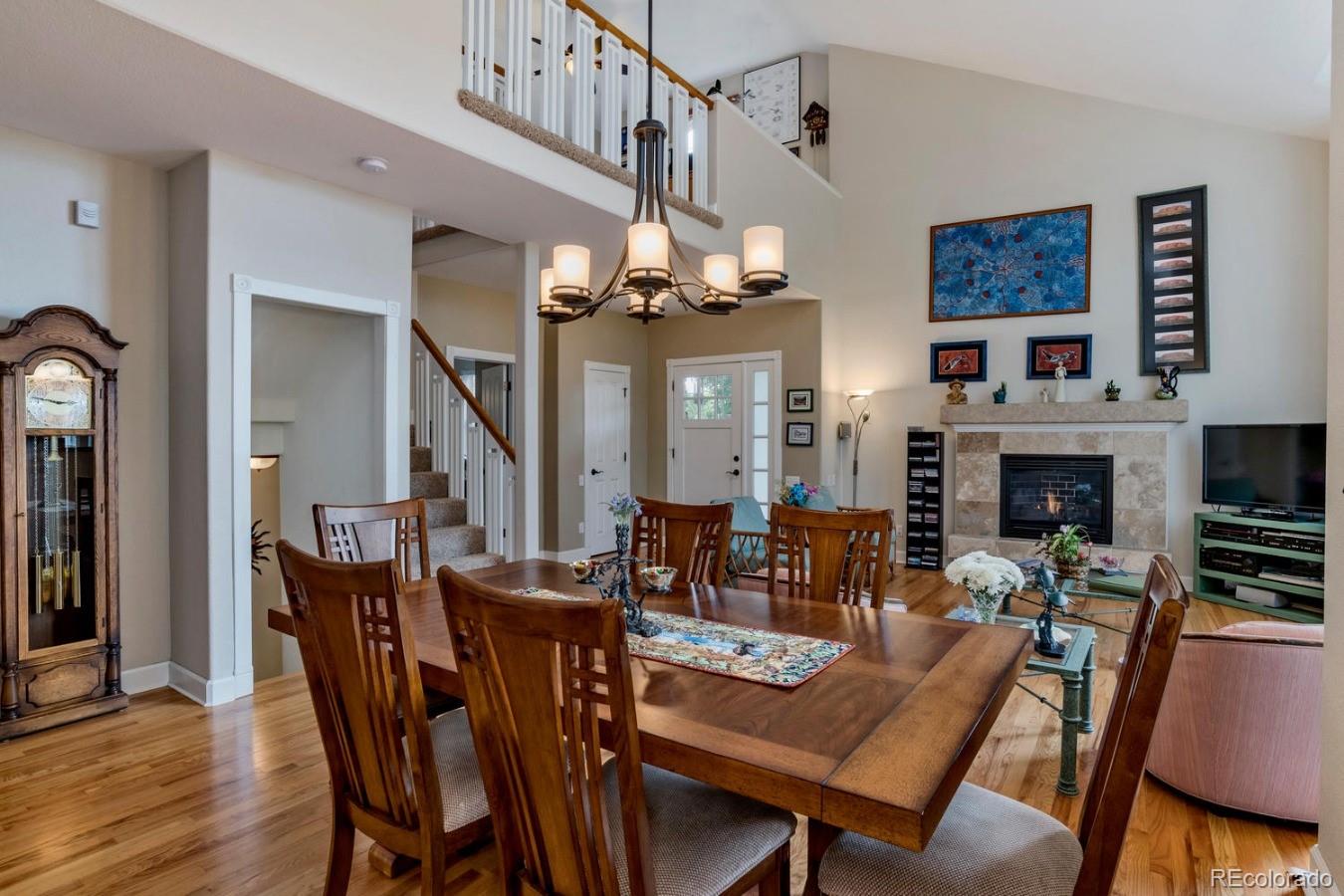 8974 Old Tom Morris Circle Highlands Ranch, CO 80129 - Photo 6 of 28 a view of a dining room with furniture wooden floor and a chandelier