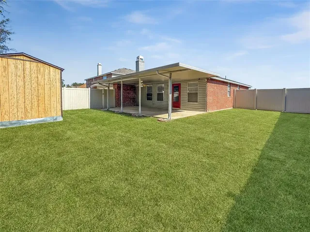 a big house with a big yard and large trees