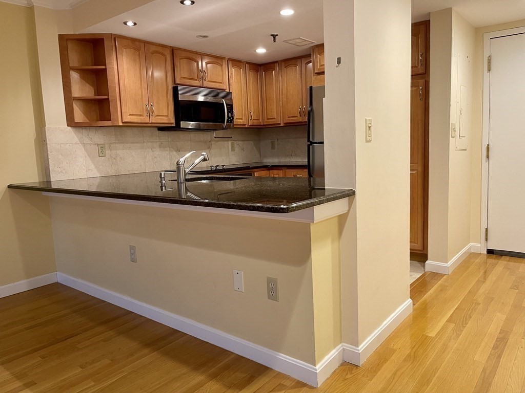 20 Webster Street, Unit 405 Brookline, MA 02446 - Photo 4 of 22 a kitchen with a sink and a stove top oven