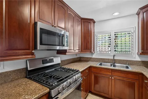 a kitchen with granite countertop a stove and a sink