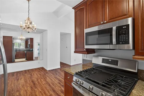 a kitchen with stainless steel appliances granite countertop a stove and a microwave