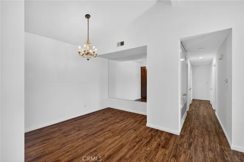 a very nice looking room with wooden floor and a chandelier