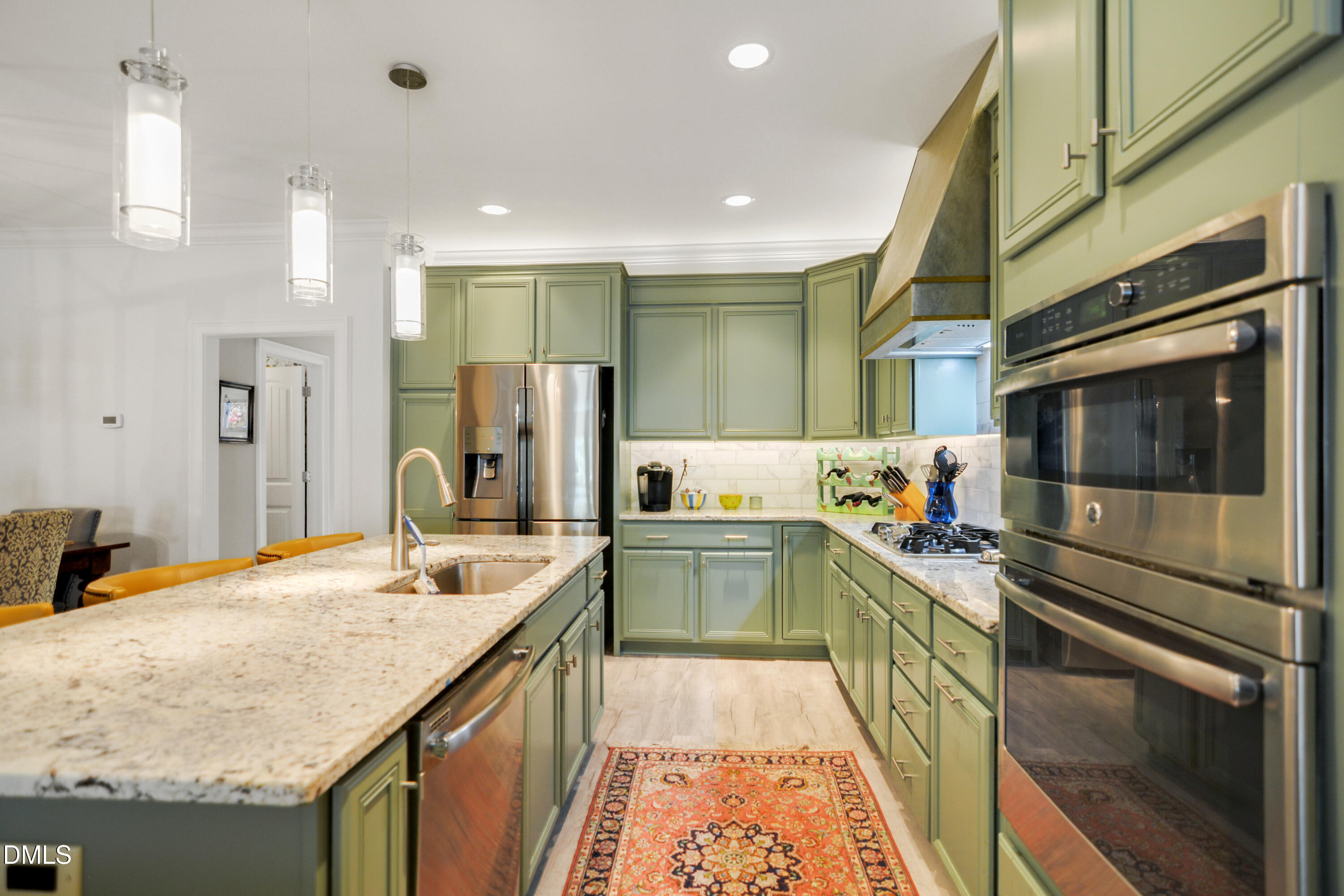 2408 Noble Road Raleigh, NC 27608 - Photo 13 of 25 a kitchen with a sink stove and cabinets