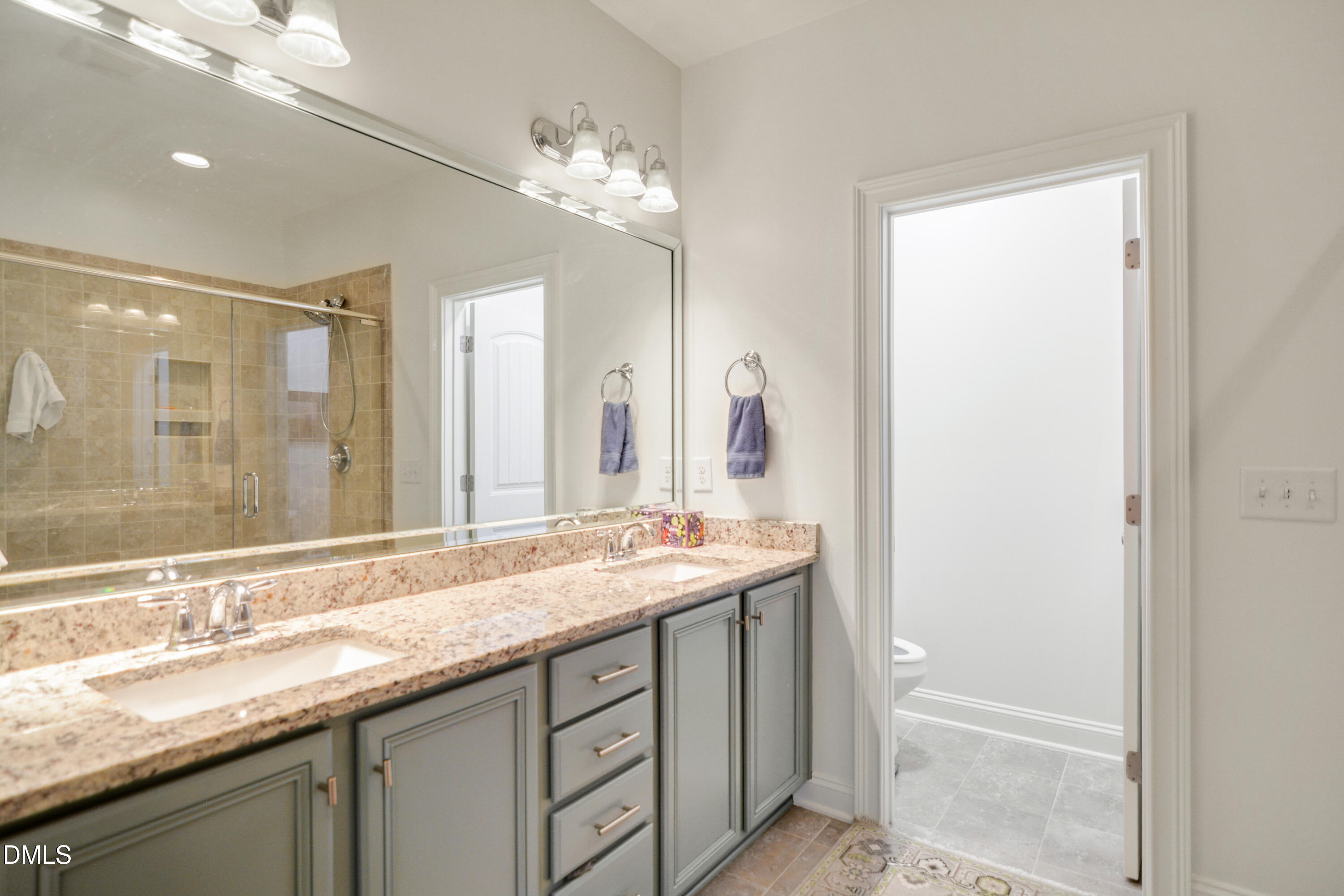 2408 Noble Road Raleigh, NC 27608 - Photo 16 of 25 a bathroom with a granite countertop sink and a mirror