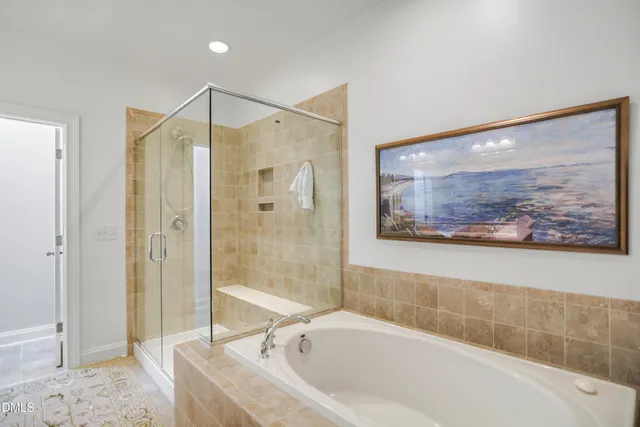 a bathroom with a bathtub and a shower