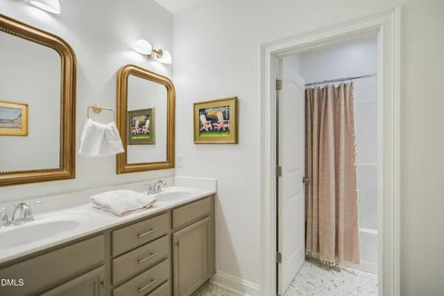 a bathroom with 2 sink and a mirror