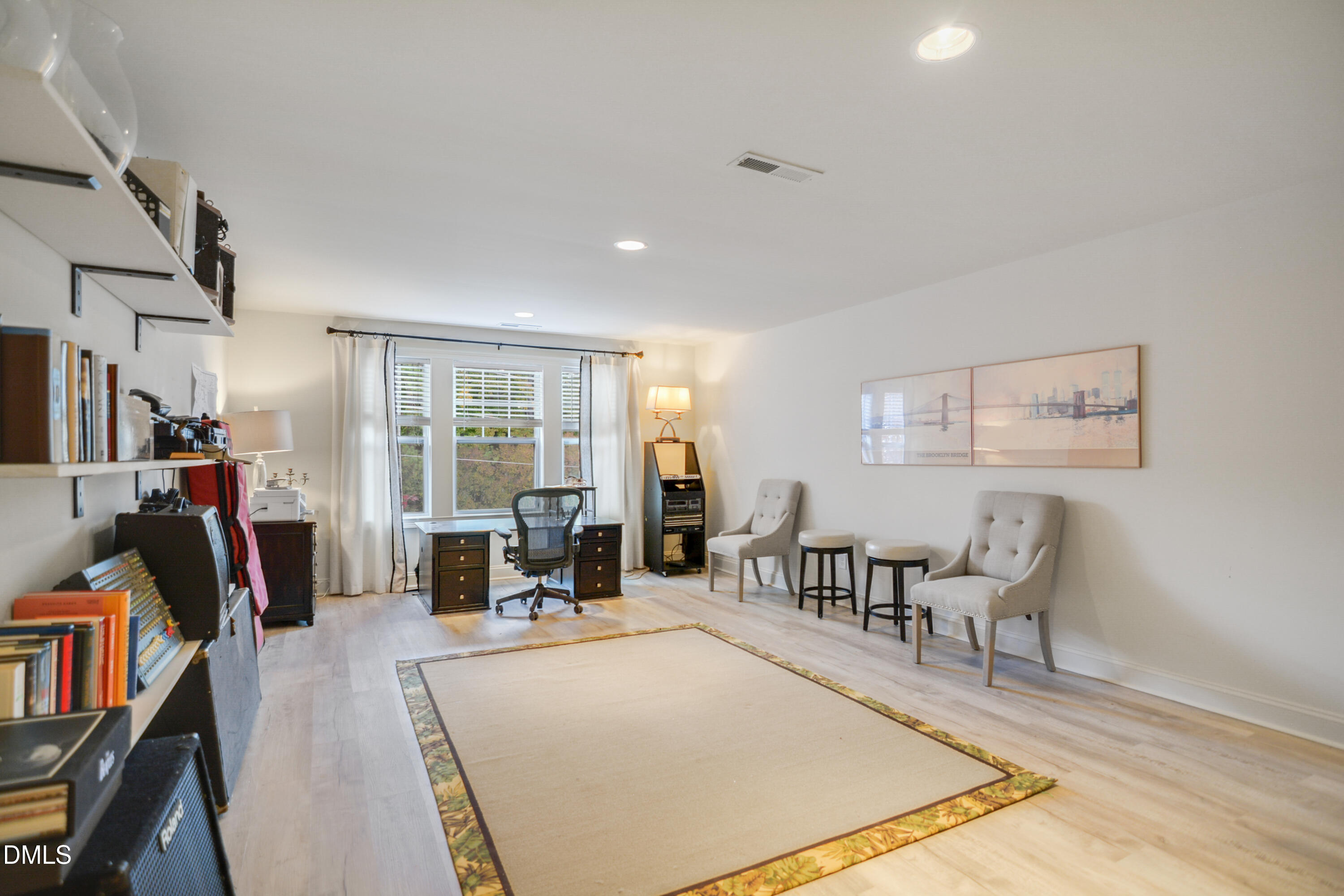 2408 Noble Road Raleigh, NC 27608 - Photo 22 of 25 a living room with furniture a flat screen tv and a table