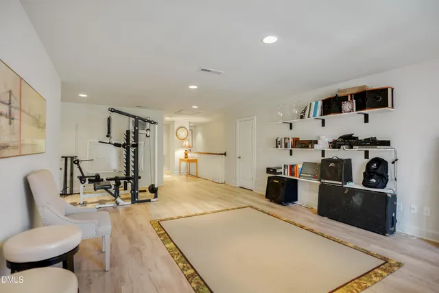 a living room with furniture a wooden floor and a sink
