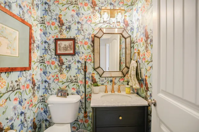 a bathroom with a granite countertop sink and a toilet