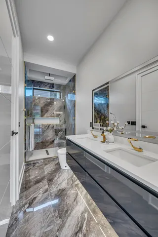 a bathroom with a double vanity sink and mirror