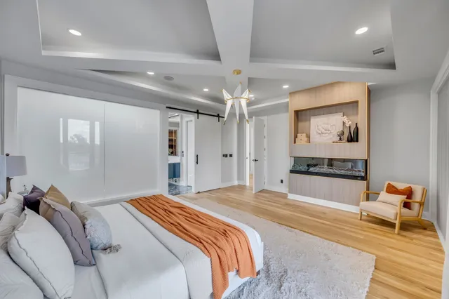 a bedroom with a bed and a mirror