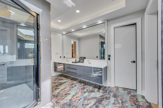a large bathroom with a glass door shower and sink