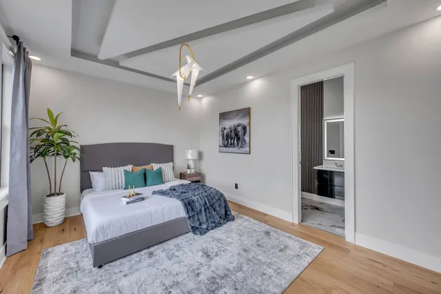 a bedroom with a large bed and a dresser