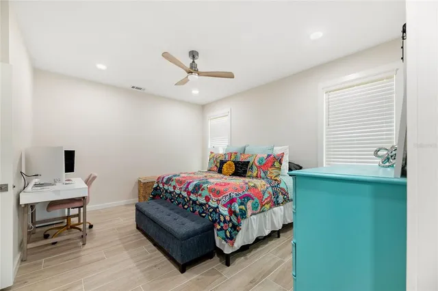 a bedroom with a bed and a window