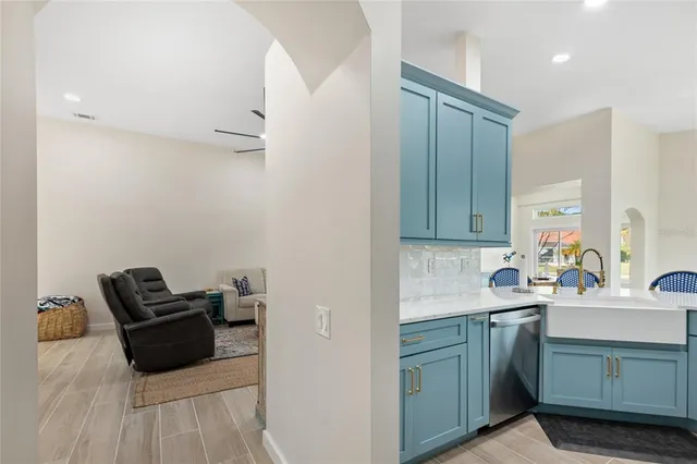 a kitchen with a sink appliances and cabinets