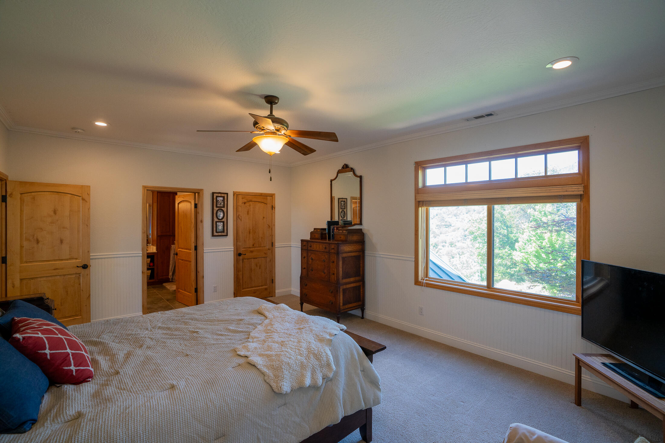 1881 Brophy Road Eagle Point, OR 97524 - Photo 69 of 130 a bedroom with a bed and a chandelier