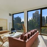 a living room with couch and a floor to ceiling window
