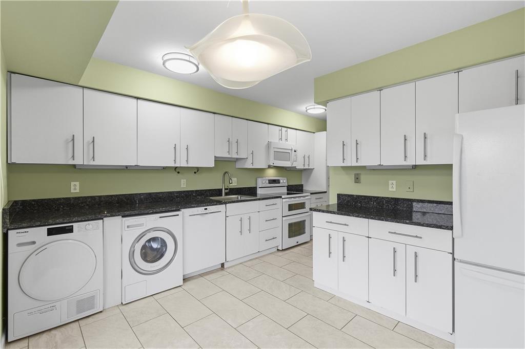 220 North Dithridge Street, Unit 805 Pittsburgh, PA 15213 - Photo 15 of 40 a kitchen with granite countertop white cabinets and white appliances