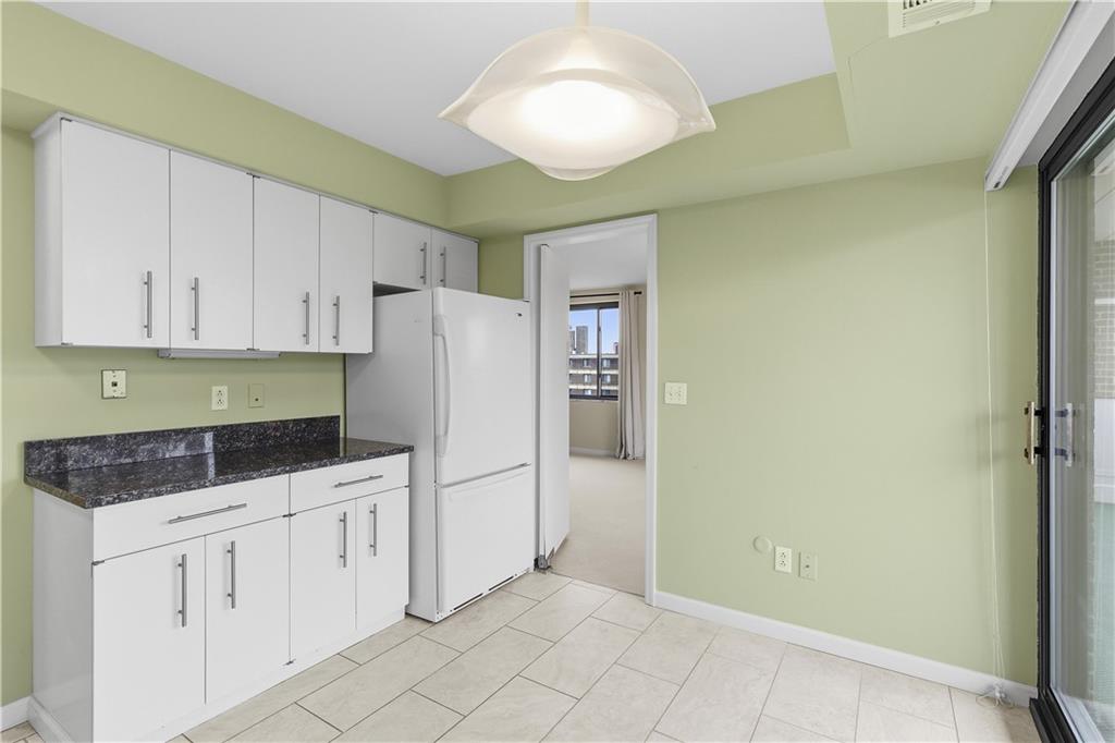 220 North Dithridge Street, Unit 805 Pittsburgh, PA 15213 - Photo 16 of 40 a kitchen with white cabinets and refrigerator