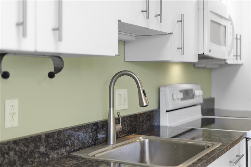 220 North Dithridge Street, Unit 805 Pittsburgh, PA 15213 - Photo 17 of 40 a kitchen with stainless steel appliances granite countertop a sink and a white cabinets