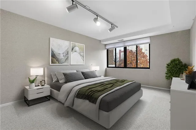 a bedroom with bed and a potted plant