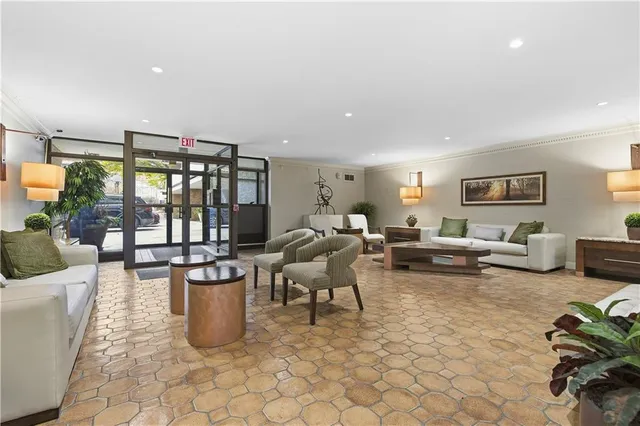 a living room with furniture a rug and a potted plant