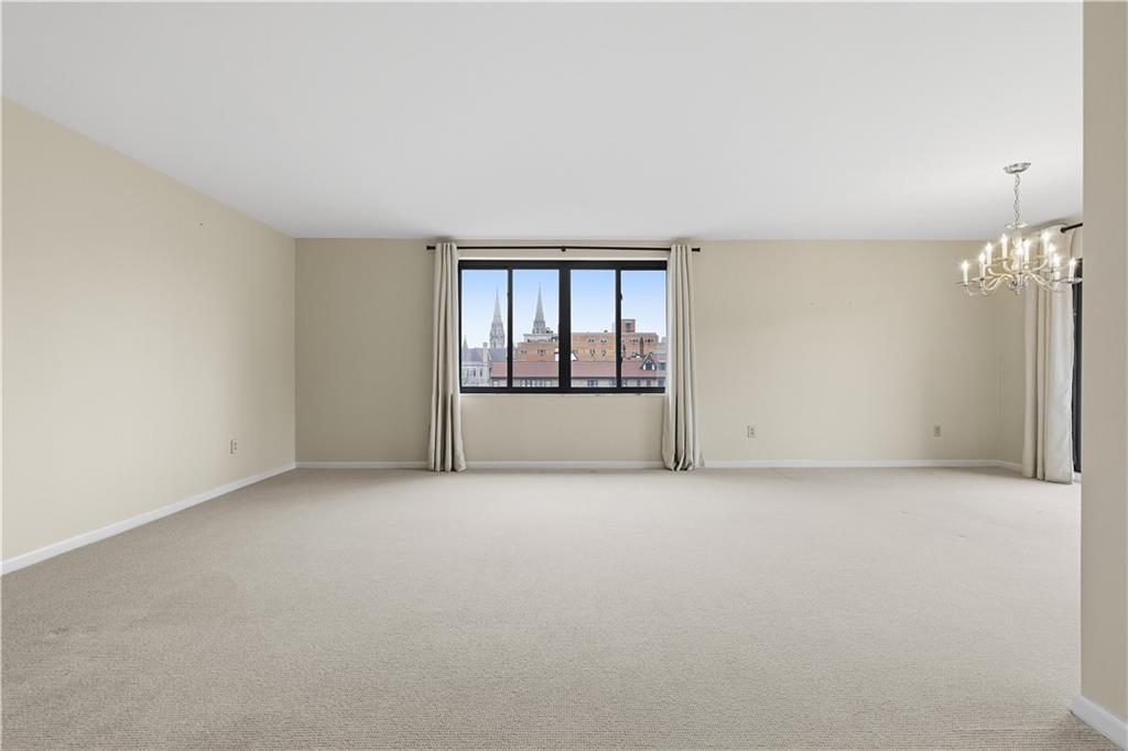 220 North Dithridge Street, Unit 805 Pittsburgh, PA 15213 - Photo 9 of 40 an empty room with chandelier fan and windows