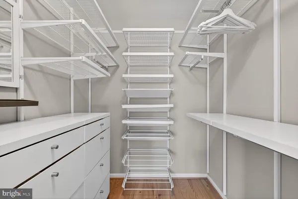 a view of walk in closet with empty racks