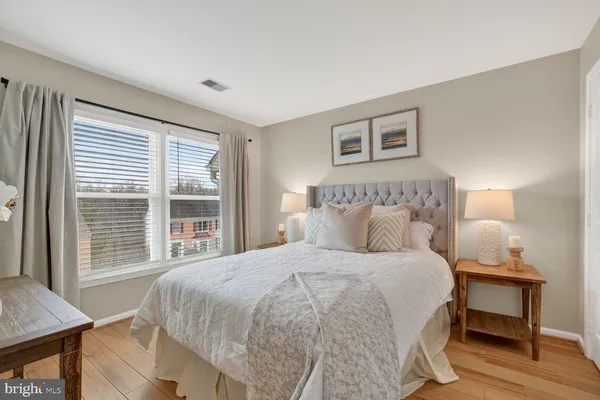 a bedroom with a large bed and a window