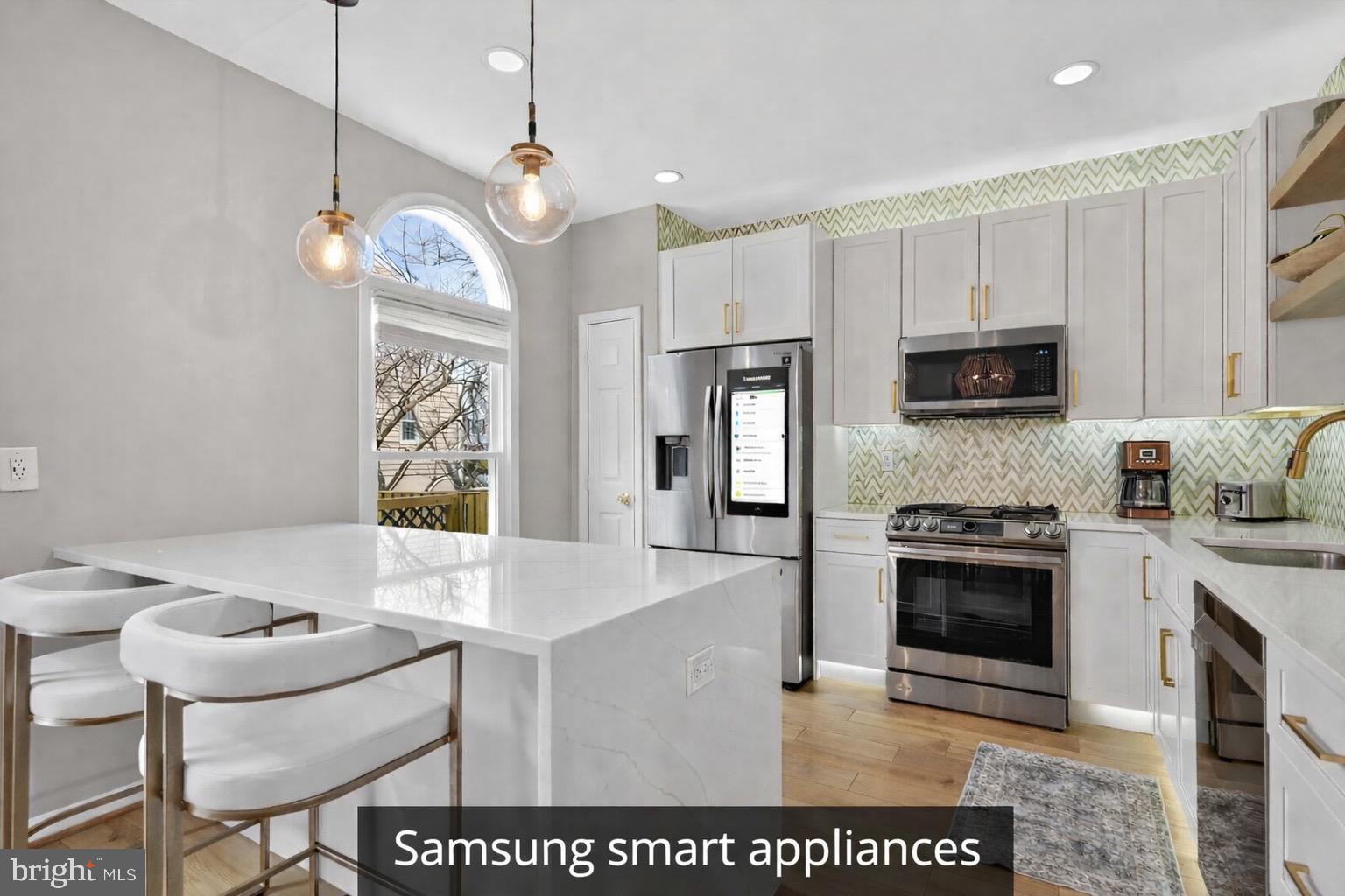 8713 Wadebrook Terrace Springfield, VA 22153 - Photo 2 of 21 a kitchen with stainless steel appliances granite countertop a stove a sink a microwave a refrigerator a counter top space and cabinets
