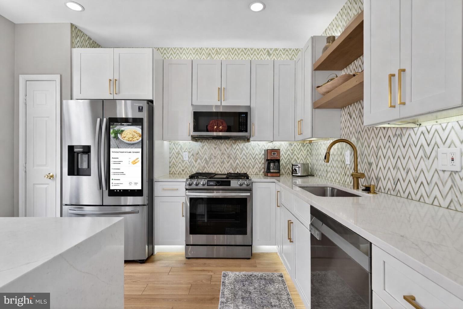 8713 Wadebrook Terrace Springfield, VA 22153 - Photo 3 of 21 a kitchen with stainless steel appliances granite countertop a refrigerator stove and sink