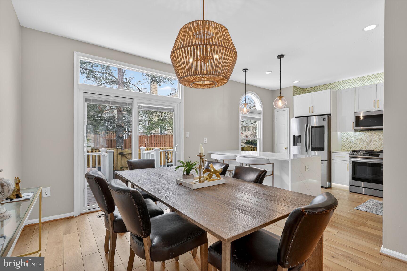 8713 Wadebrook Terrace Springfield, VA 22153 - Photo 4 of 21 a dining room with furniture a chandelier and wooden floor