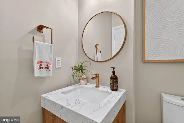 a bathroom with a sink a mirror and vanity